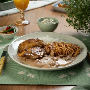 Raízes da Travessia: roasted chicken thigh with white rice, tutu de feijão, tomato pasta and Brazilian potato salad