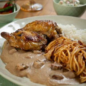Raízes da Travessia: roasted chicken thigh with white rice, tutu de feijão, tomato pasta and Brazilian potato salad