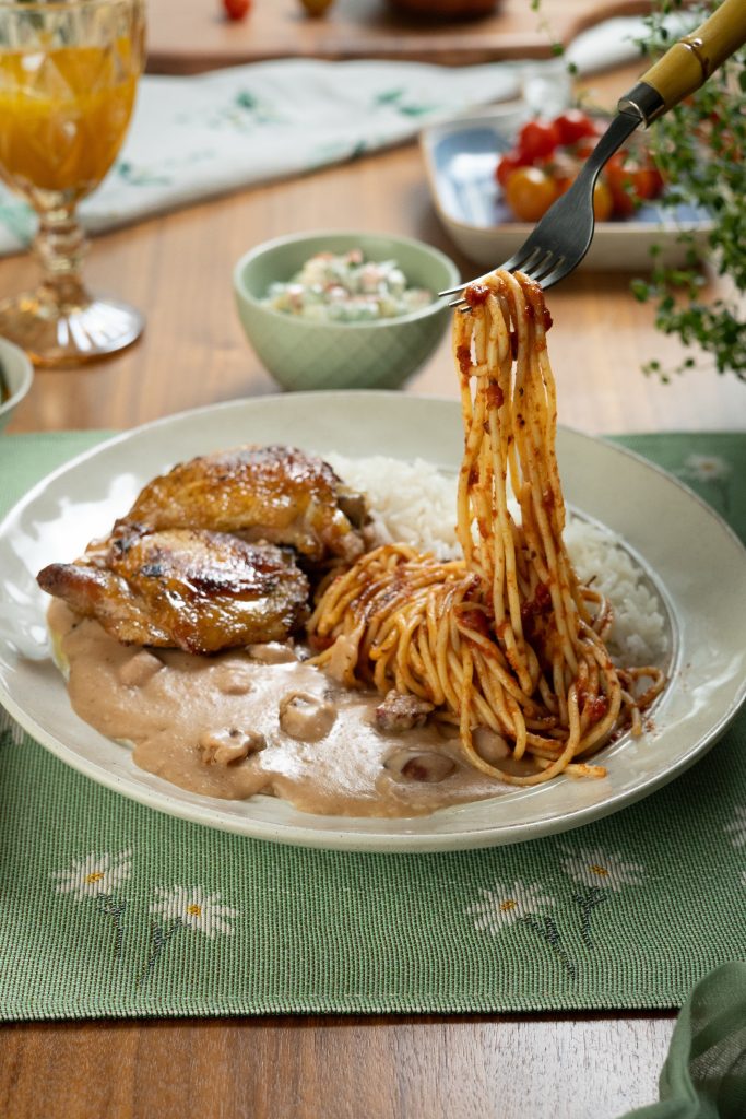 Raízes da Travessia: roasted chicken thigh with white rice, tutu de feijão, tomato pasta and Brazilian potato salad